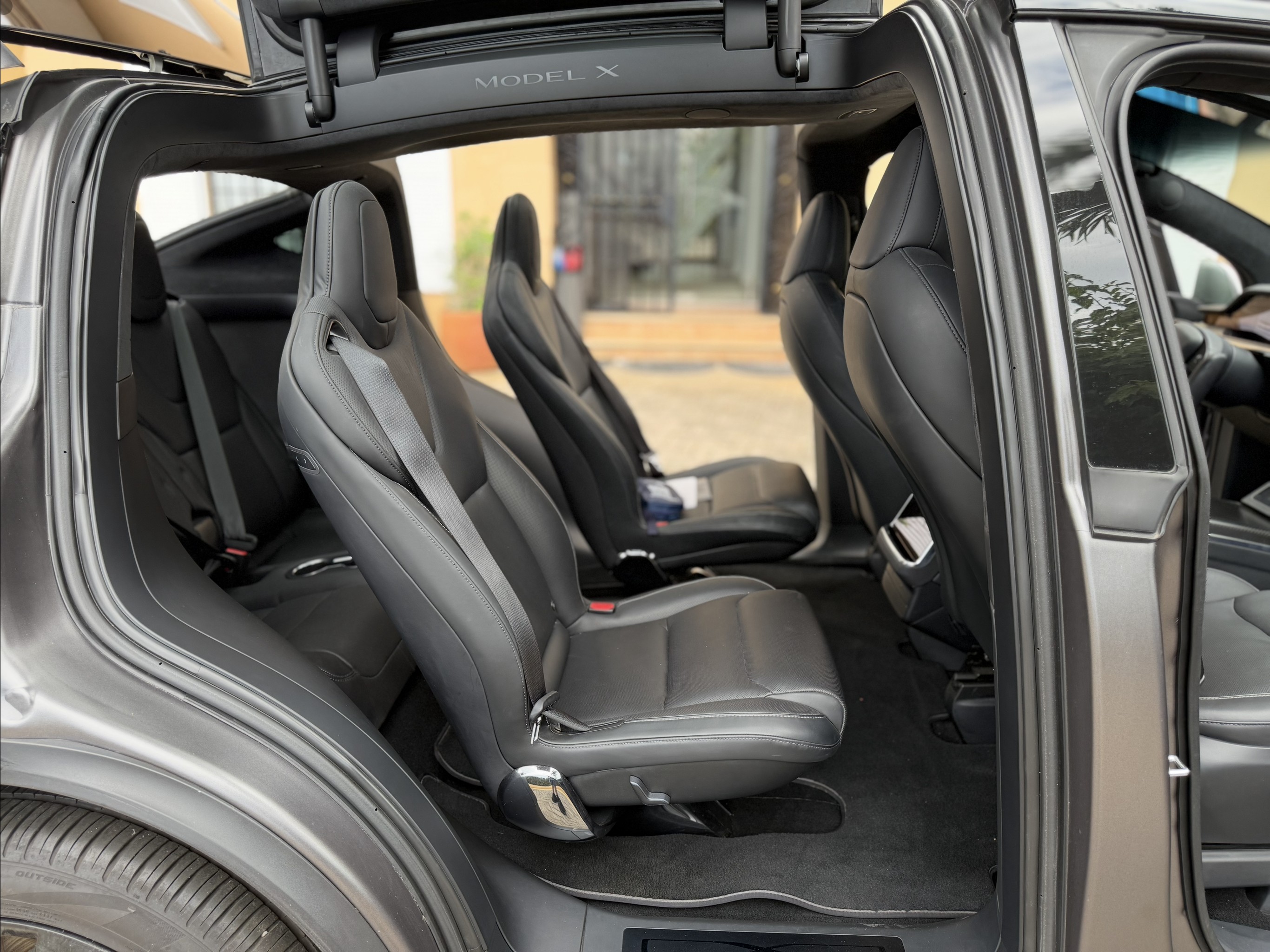 Tesla Model X Plaid second‑row seats with falcon‑wing doors open