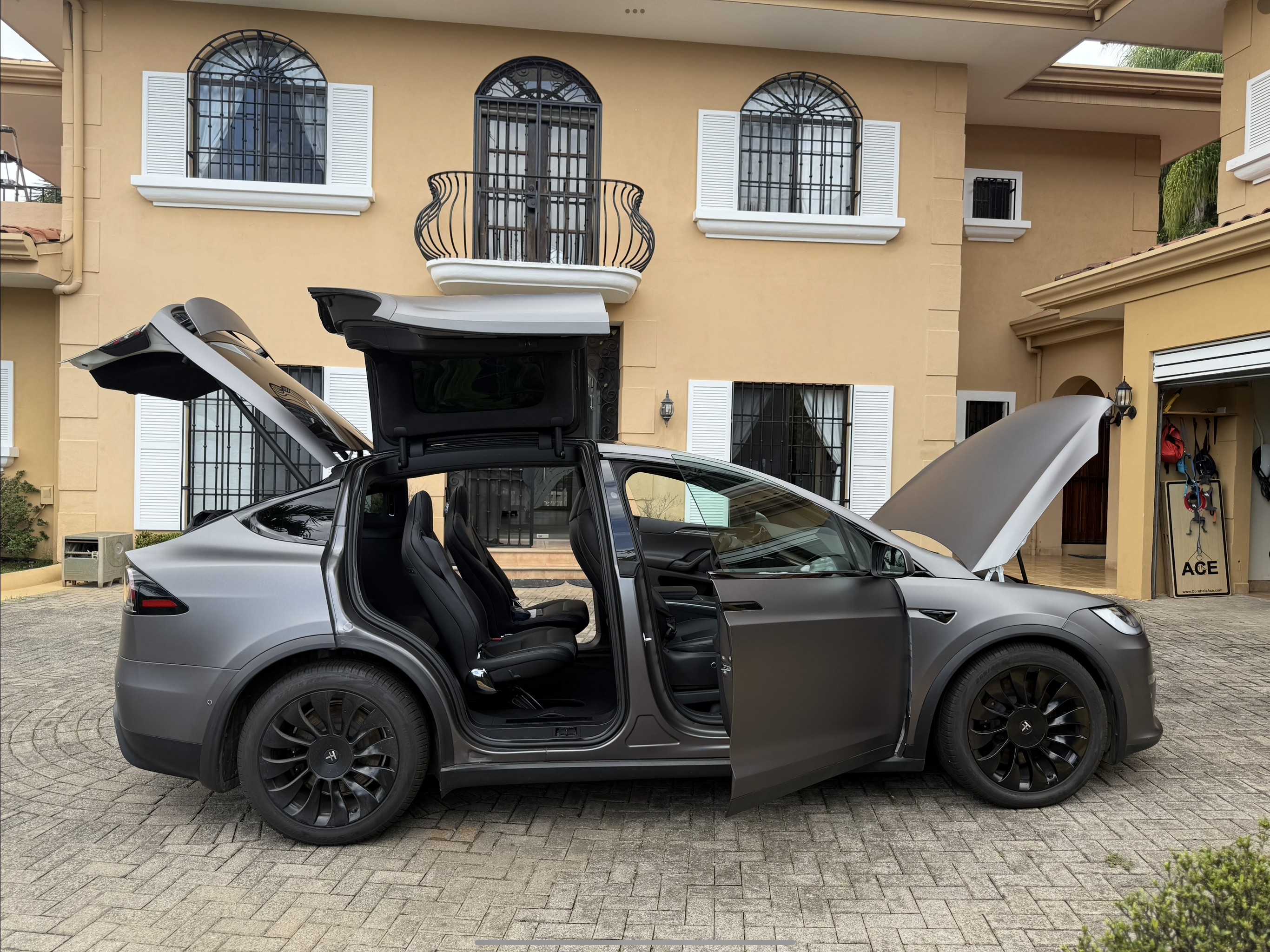Tesla Model X Plaid driver‑side view with doors and frunk open